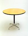 Charles Eames Aluminium Group table. Circular light oak veneered work surface supported on a single black painted pedestal and four-star 'universal' aluminum base. 91cm diameter x 72cm high. Manufactured by Herman Miller. Photography 2007 Graham Mancha